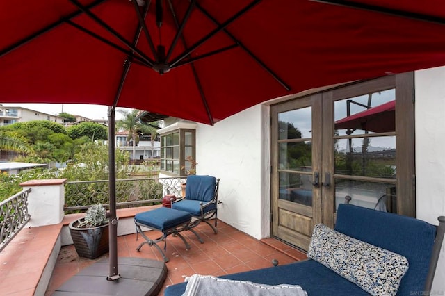 view of patio / terrace with french doors and a balcony