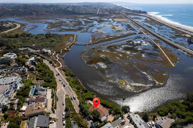 drone / aerial view featuring a water view and a beach view