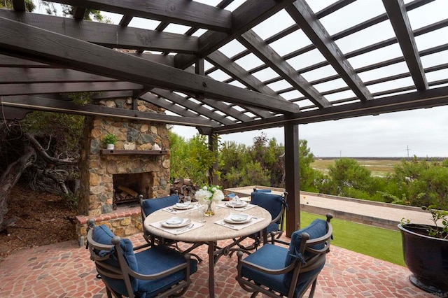 view of patio / terrace with a pergola and an outdoor stone fireplace