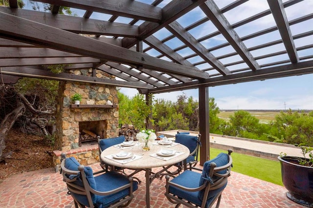 view of patio featuring an outdoor stone fireplace and a pergola