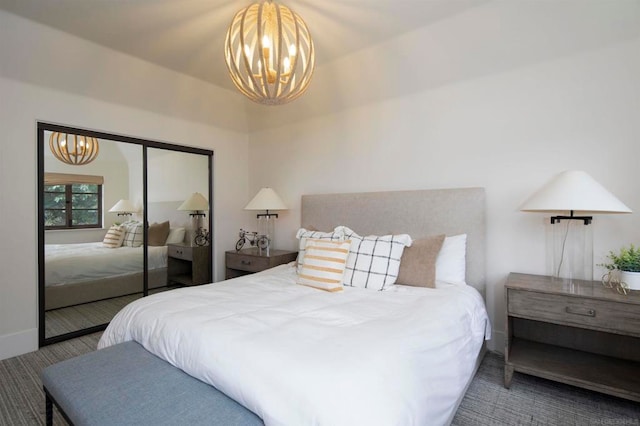 carpeted bedroom featuring a closet and a chandelier