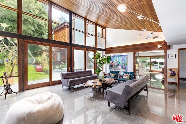 living room featuring wood ceiling and a towering ceiling