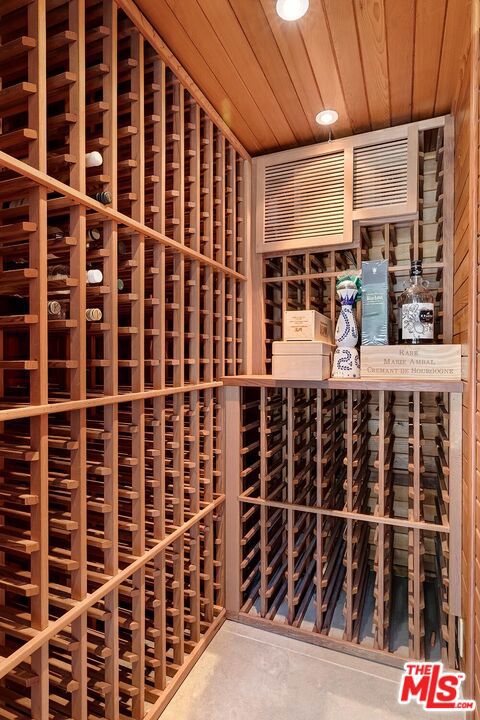 wine area featuring wooden ceiling and concrete floors