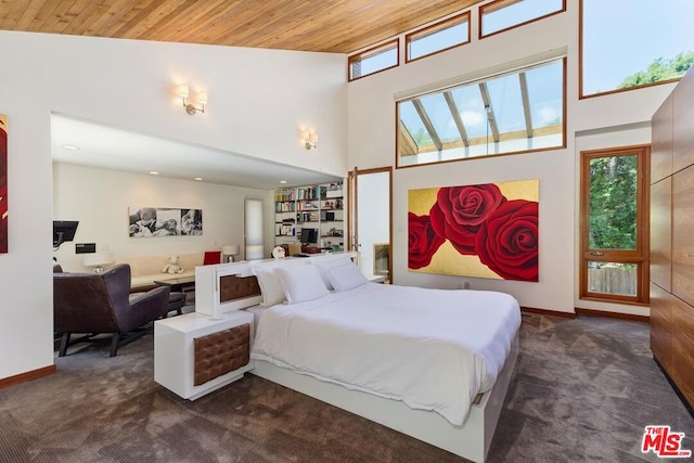 carpeted bedroom with multiple windows, a high ceiling, and wooden ceiling