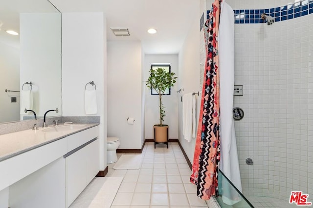 bathroom featuring tile patterned flooring, vanity, toilet, and a shower with curtain