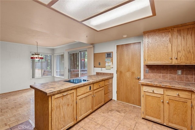 6032 Tiffin Ct, Magalia, CA 95954 - kitchen featuring a peninsula, black electric stovetop, tasteful backsplash, and pendant lighting