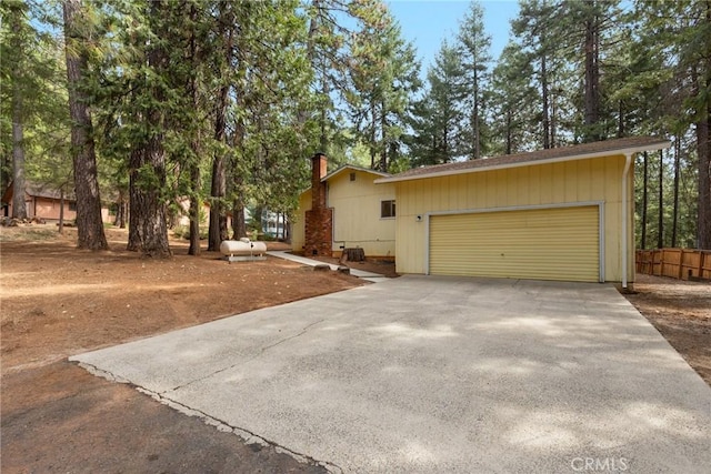 6032 Tiffin Ct, Magalia, CA 95954 - view of property exterior featuring a chimney, driveway, and a garage