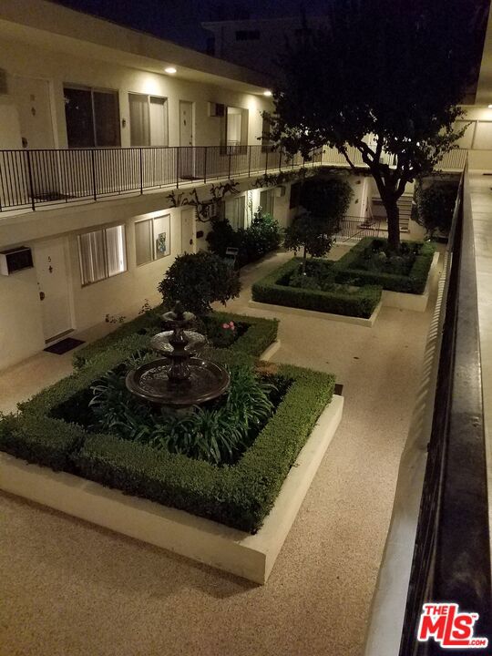 yard at twilight featuring a balcony