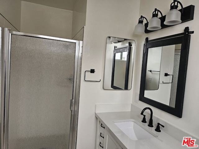 bathroom featuring vanity, a chandelier, and an enclosed shower