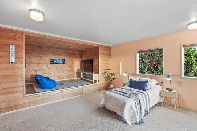 carpeted bedroom with wood walls