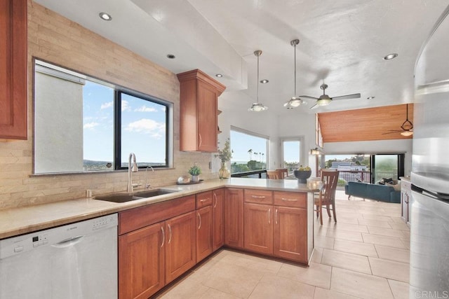 kitchen with a wealth of natural light, sink, white dishwasher, and ceiling fan