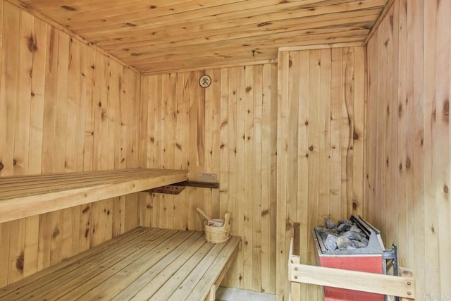 view of sauna / steam room featuring wood walls and wooden ceiling