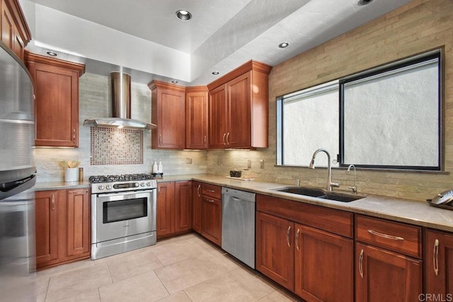 kitchen with sink, wall chimney range hood, decorative backsplash, appliances with stainless steel finishes, and light tile patterned floors