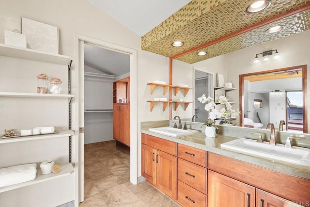 bathroom featuring vaulted ceiling and vanity