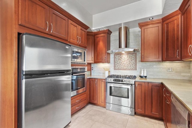 kitchen featuring wall chimney exhaust hood, decorative backsplash, appliances with stainless steel finishes, and light tile patterned floors