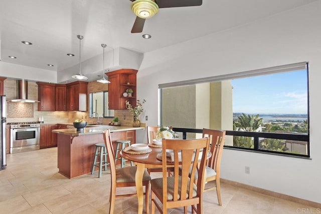 dining area featuring ceiling fan and sink