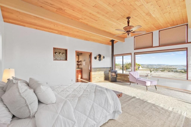 bedroom featuring carpet floors, wood ceiling, ceiling fan, and a wood stove