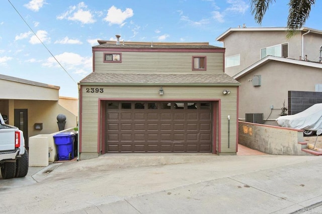 view of front property with a garage and central AC