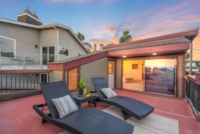 patio terrace at dusk with a balcony