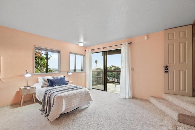 bedroom with access to outside and light colored carpet