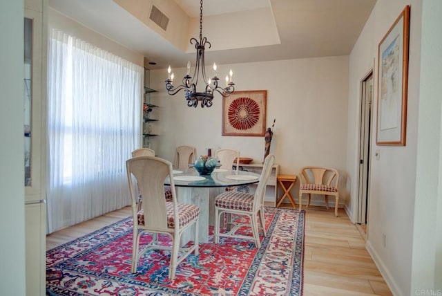 dining room featuring an inviting chandelier and light hardwood / wood-style floors