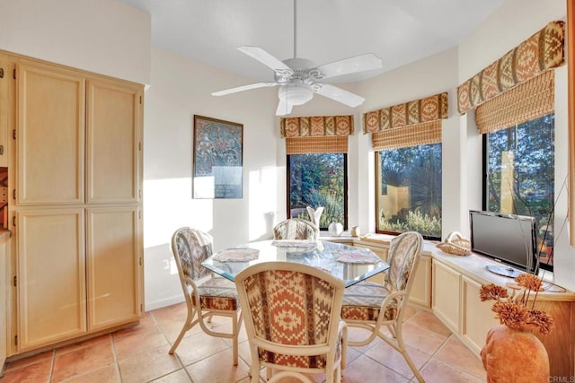 tiled dining room featuring a healthy amount of sunlight and ceiling fan