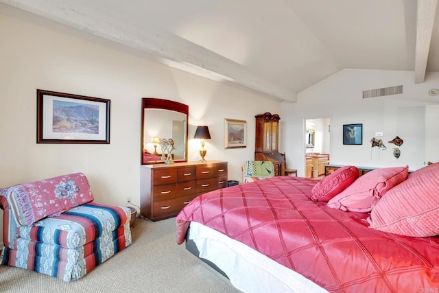 carpeted bedroom with lofted ceiling with beams and ensuite bath