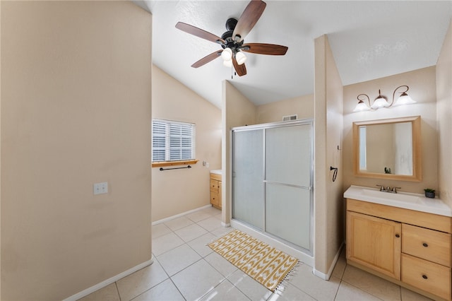 full bathroom featuring a ceiling fan, baseboards, vanity, and a shower stall