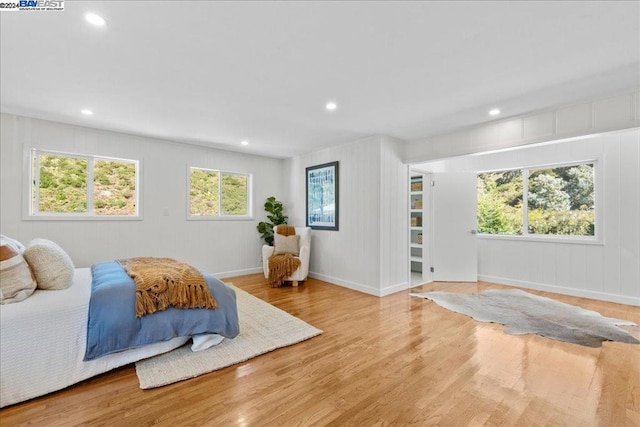 bedroom featuring light hardwood / wood-style floors and multiple windows