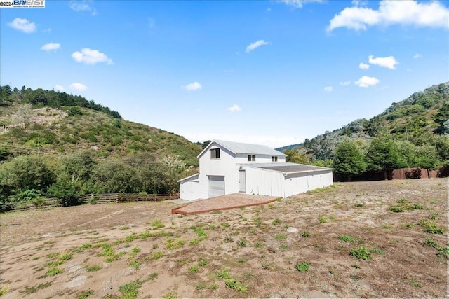 view of side of property featuring a mountain view and a rural view