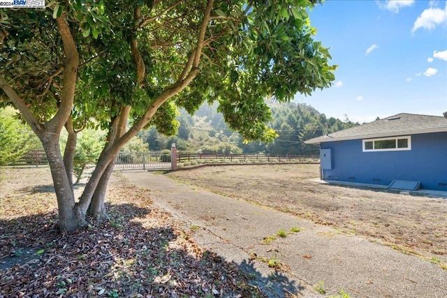 view of yard with a rural view