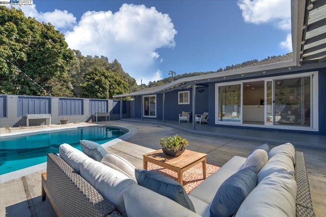 view of pool featuring an outdoor living space and a patio