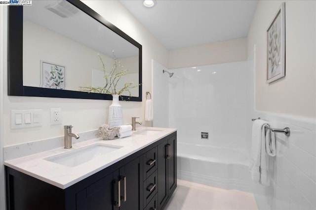 bathroom featuring vanity and tiled shower / bath combo