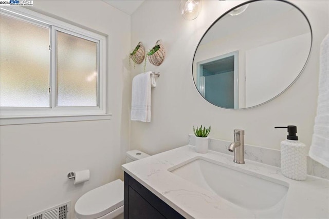 bathroom featuring vanity and toilet