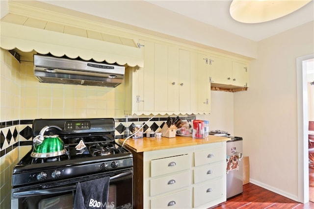 kitchen featuring tasteful backsplash, black gas range oven, ventilation hood, and dark hardwood / wood-style flooring