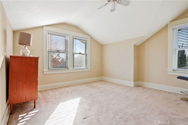 bonus room with vaulted ceiling, light colored carpet, and ceiling fan