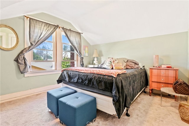 bedroom featuring lofted ceiling and light carpet