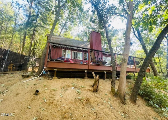 rear view of house with a wooden deck