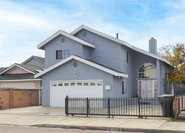 traditional-style home with a fenced front yard, driveway, a chimney, and stucco siding