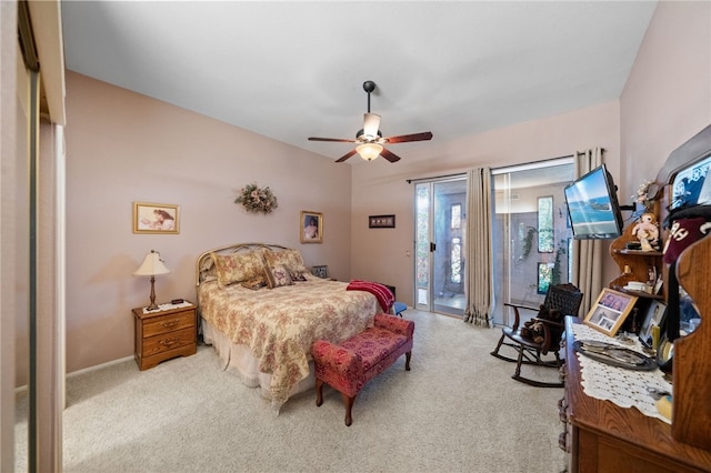 carpeted bedroom with ceiling fan and access to exterior