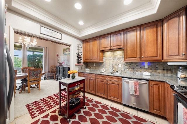 kitchen featuring light stone counters, sink, tasteful backsplash, appliances with stainless steel finishes, and light colored carpet