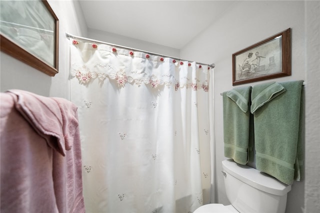 bathroom with shower / tub combo and toilet