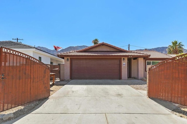 single story home with a garage and a mountain view