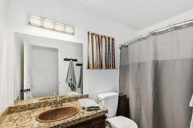 bathroom featuring toilet and vanity