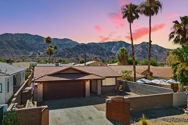 view of front of home with a mountain view and a garage