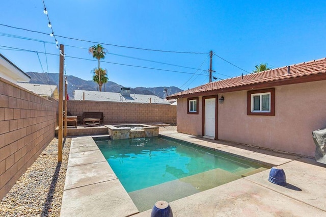 view of swimming pool with an in ground hot tub, a mountain view, and a patio