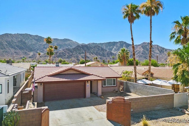 view of front of house featuring a mountain view and a garage