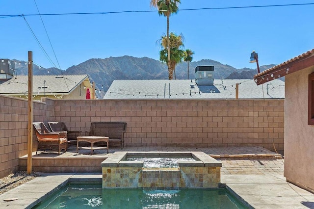 view of swimming pool featuring a patio area and a mountain view