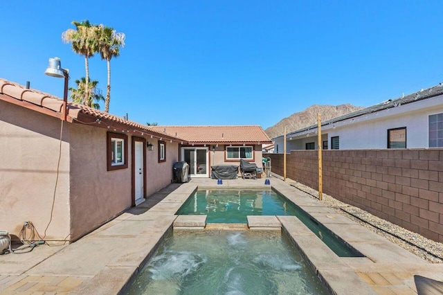 view of swimming pool with a patio area and an in ground hot tub