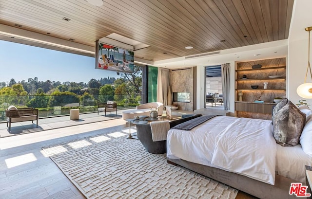 bedroom featuring light hardwood / wood-style floors and wood ceiling